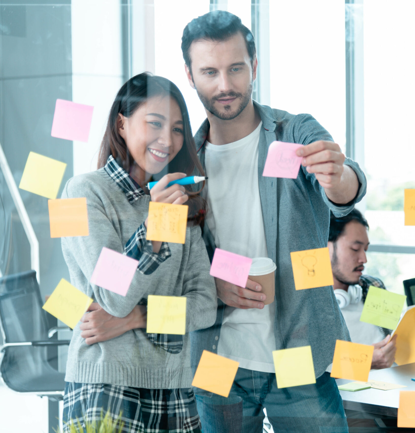 Brainstorming diversity creative design use post it sticky note team meeting with startup teamwork. Collaborative brainstorm teams meeting with business partners share ideas teamwork in conference Kollegen im Büro arbeiten mit Klebezetteln an einer Strategie